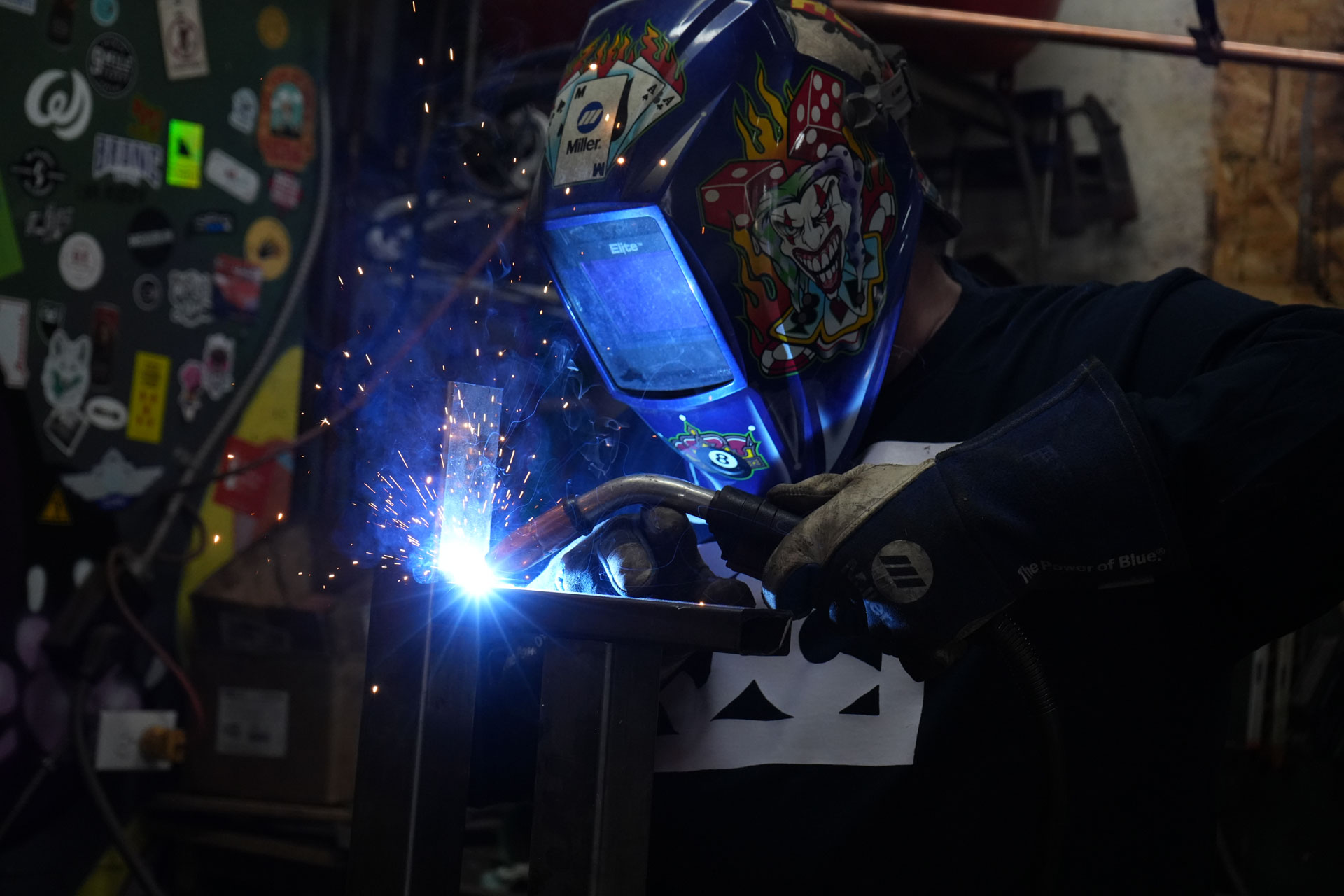 Sparks flying as a fabricator welds a steel frame