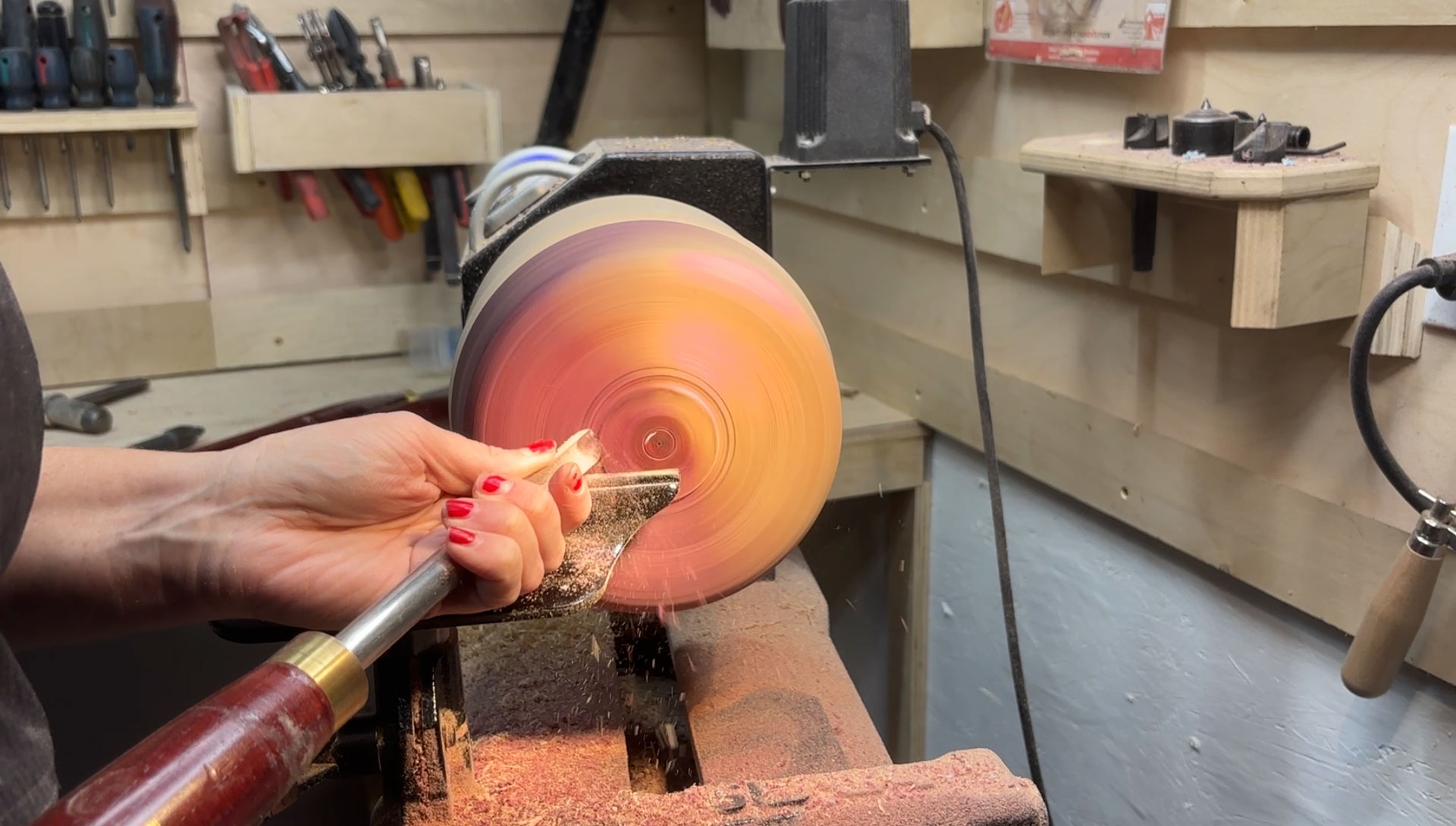 Turning a bowl on the lathe in a shop bay